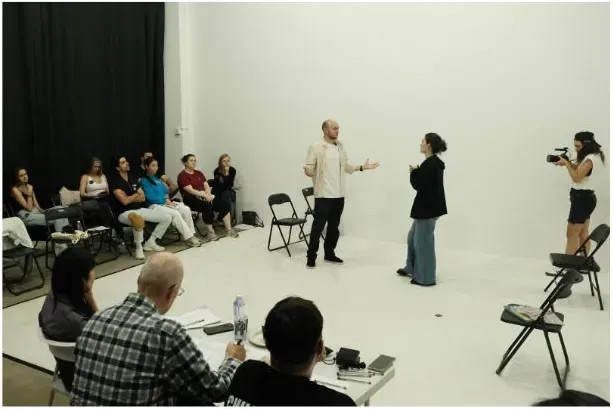 The class watching a scene on the white cyclorama floor at PAFI Studio